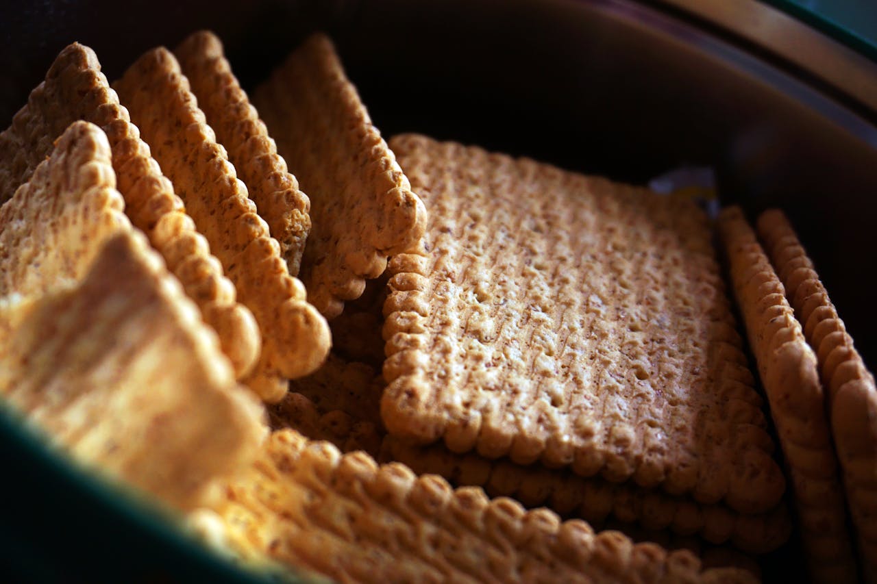Delicious crunchy biscuits stacked neatly in a tin, perfect snack imagery.
